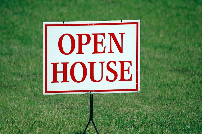 Illustration: An open house sign stands in a grassy yard