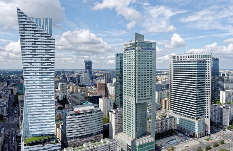 Illustration: Tall skyscrapers rise above the cityscape of Warsaw
